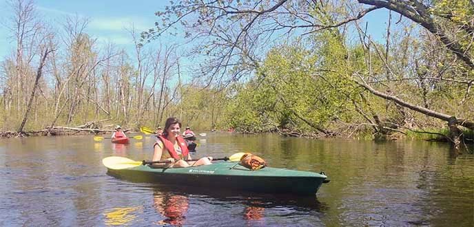 Kayakers paddle on a spring day. Kayakers paddle on a spring day.