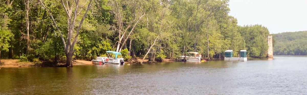 Boats Along the river shore Boats are tied up along a river shore.
