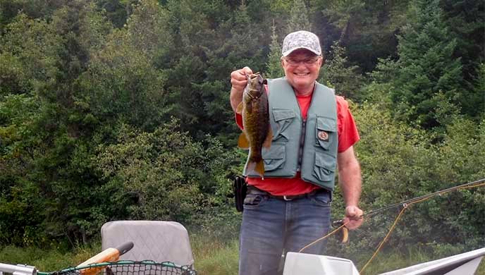 A man holds a fish.
