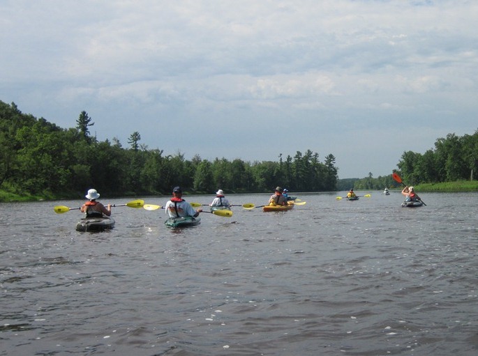 A small group of kayakers learn about the river from a park ranger in this image. NPS photo.