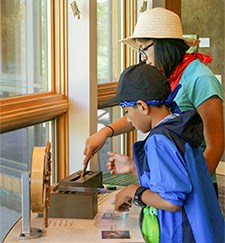 Young people interact with a display.