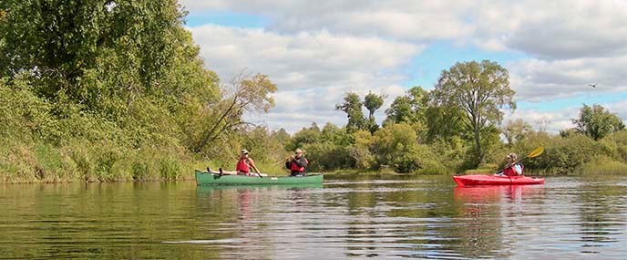 Paddlers enjoy a calm day on a river.