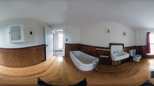 Distorted 360-panoramic image of a room with wood floors