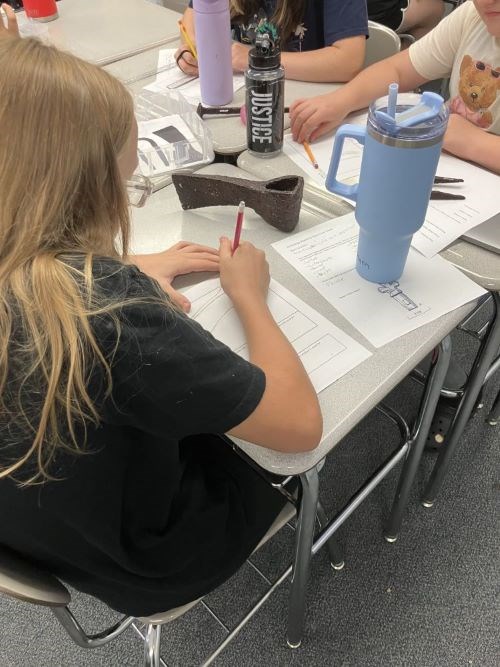 Student explores replica artifact