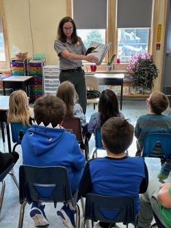 Ranger reading book to students