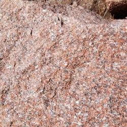 a pink rock with specks of white and grey