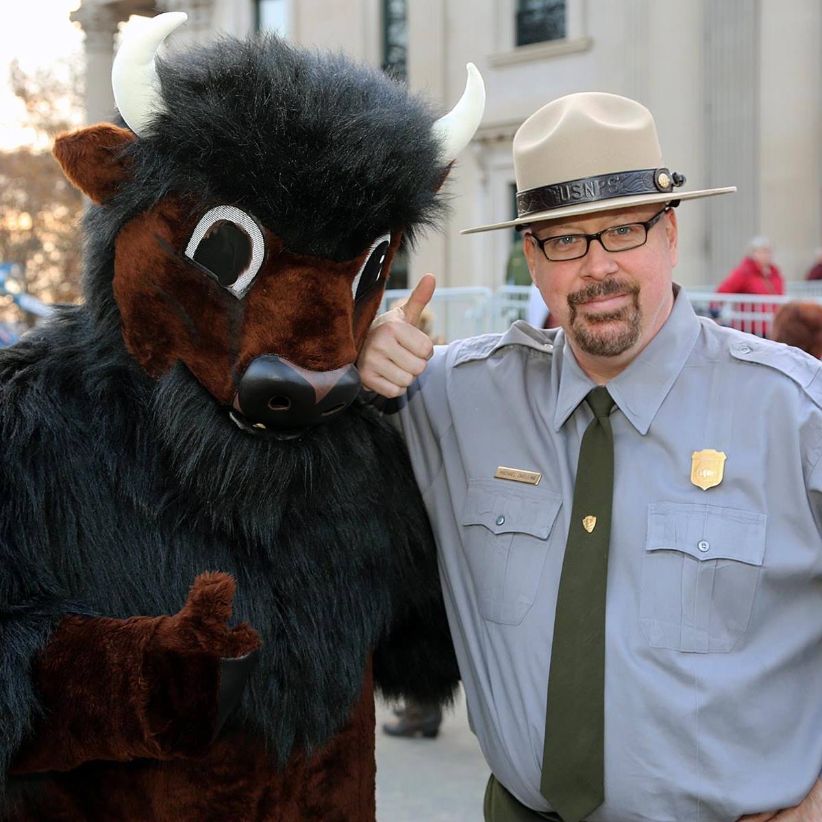 Park ranger standing beside a person in a bison costume