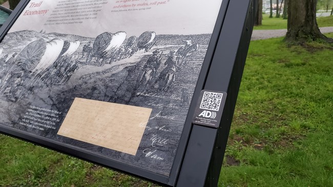 A round medallion on a wayside exhibit.