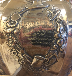 Inscription on the side of a silver pitcher reading Geo Gretton second officer of the San Francisco by the merchants of Boston in acknowledgement of his gallant conduct on the occasion of the wreck of that steamer
