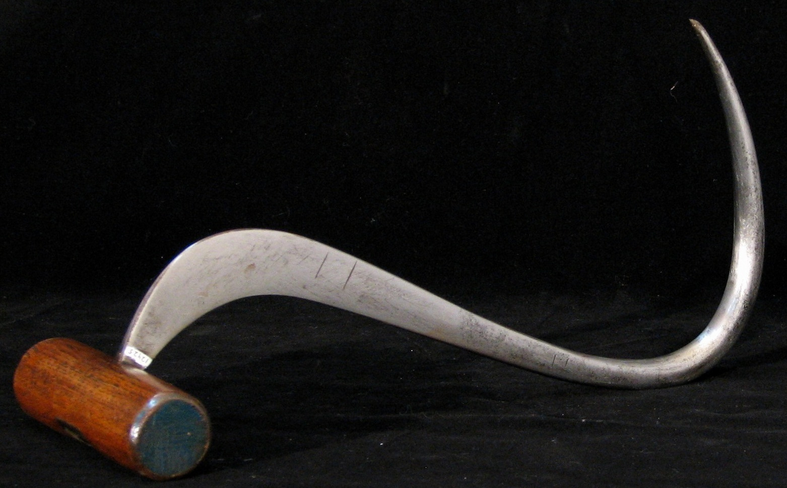 Metal cargo hook from the park's collection. Metal hook with a wooden handle.