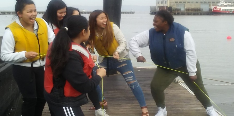 Students hauling a settling plate from the Cove floor