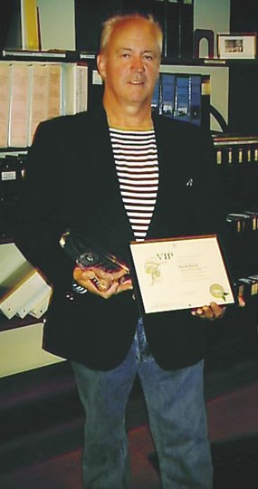 David Hirzel standing in the park's library and holding his awards in his hands. David Hirzel standing in the park's library and holding his awards in his hands.