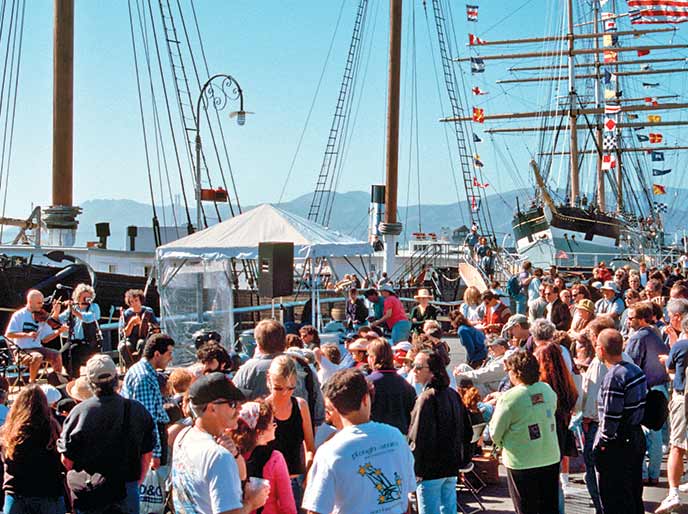 A crowd of people on a pier. A crowd of people on a pier.