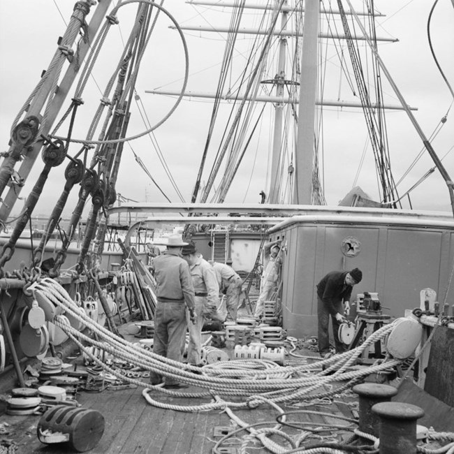 historic photo of the deck of Balclutha with men working on the ship