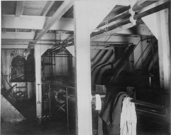 The dark, oily interior of a steamship.