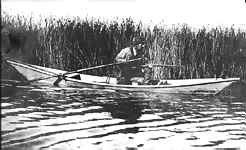 Man in Tule boat