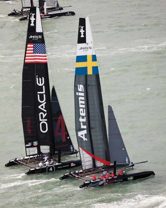 Two catamaran sailboats on the water.