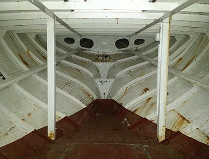 A view of inside the hull, near the bow, of a steel tugboat built in 1914.