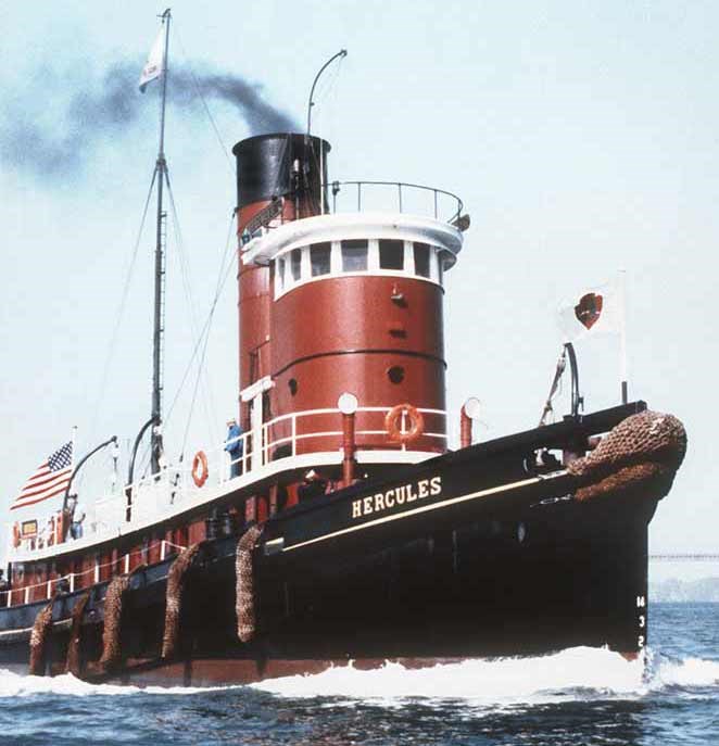A red tugboat moving through the water.