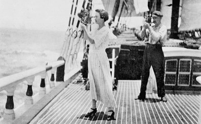 A woman on a sailing ship taking a sight with a sextant.