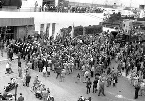 Large group of people gathered in front of the Bathhouse building.