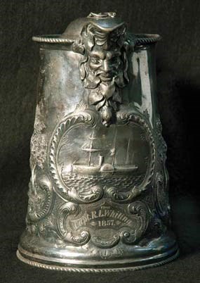 A front view of a silver pitcher. A front view of a silver pitcher.