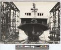 Black and white photo of the ship sliding down the ways