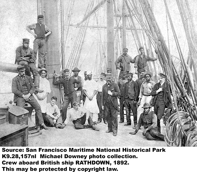 The crew of a square rigged sailing vessel posing on the main deck.