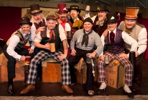 Brass Farthing Band Nine members of the band Brass Farthing seated and grinning into the camera