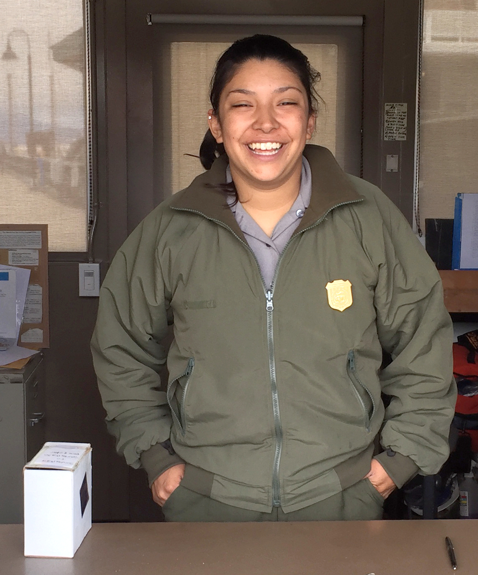 Uniformed ranger standing in the Hyde Street Pier fee booth
