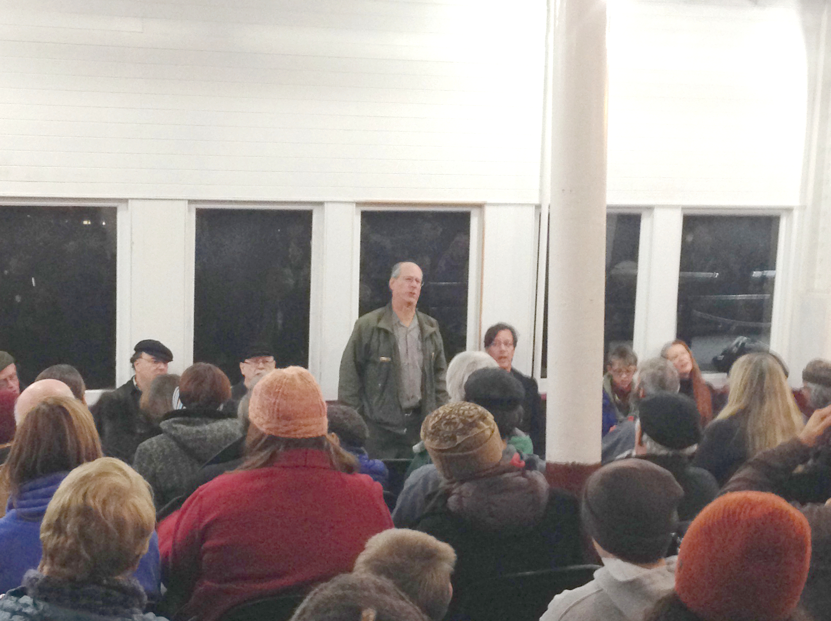 Ranger standing in front of visitors leading a chantey singalong.