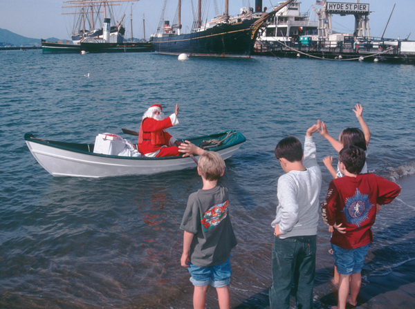 Santa rowing a boat.