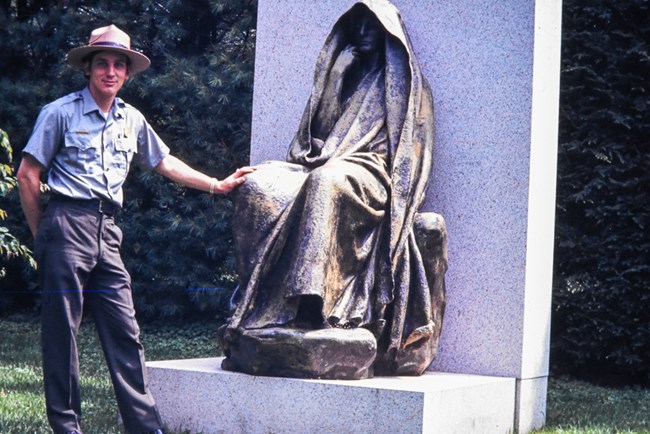 ranger standing with sculpture