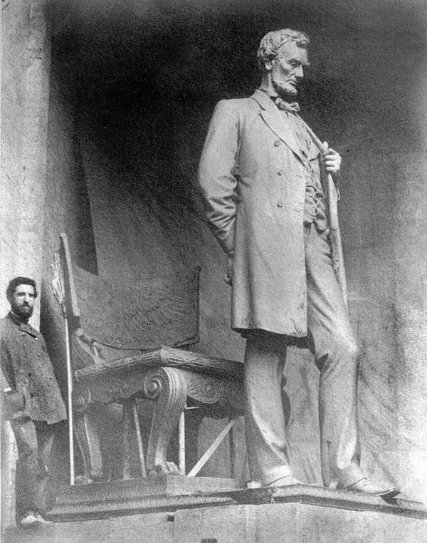 Augustus Saint-Gaudens with the full-size clay model of the "Standing Lincoln", in his studio, Cornish, N.H. 1886.