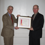 Trustee, Charles Platt presenting AAM accreditation certificate to superintendent, B.J. Dunn,