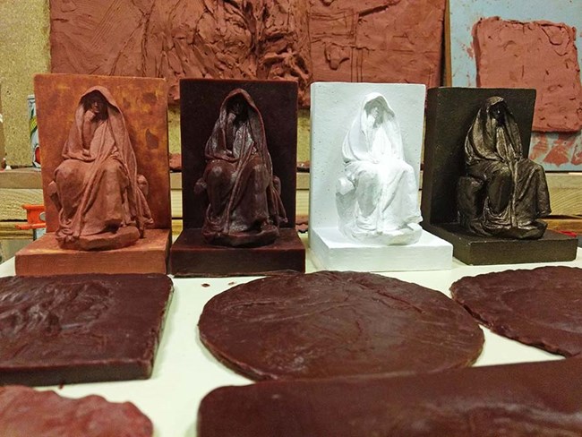 Images of the 4 stages of creating a bronze statue