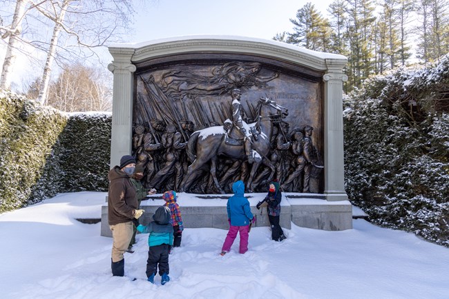 people in front of Civil War sculpture in winter