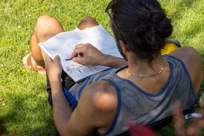 person drawing on landscape