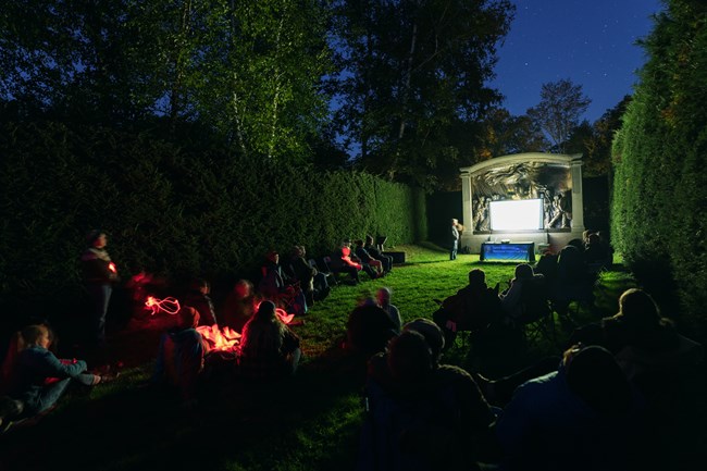 group gathered in dark for presentation
