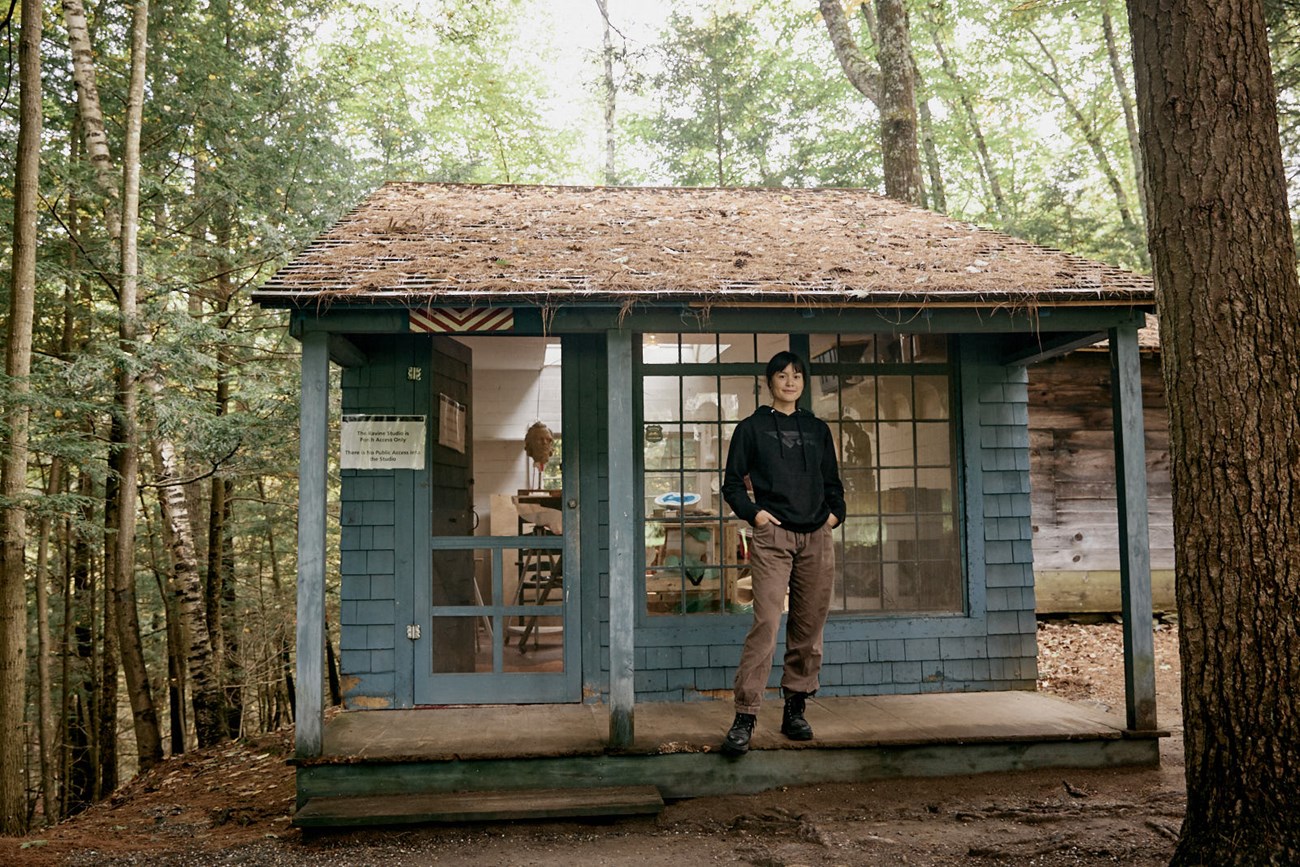 sculptor standing in front studio