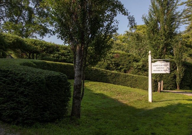 hedges with park sign