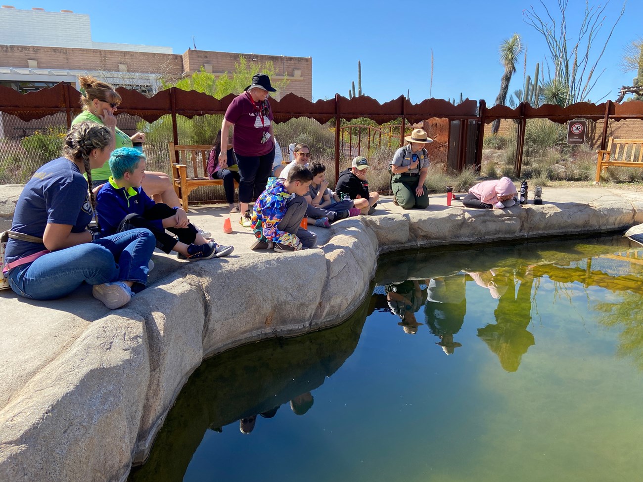 students gathered around replica desert tinaja