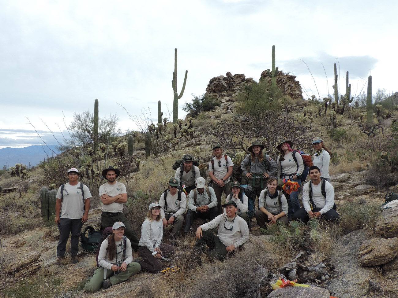 Group photo of trail crew out in the  field in their uniform after the census