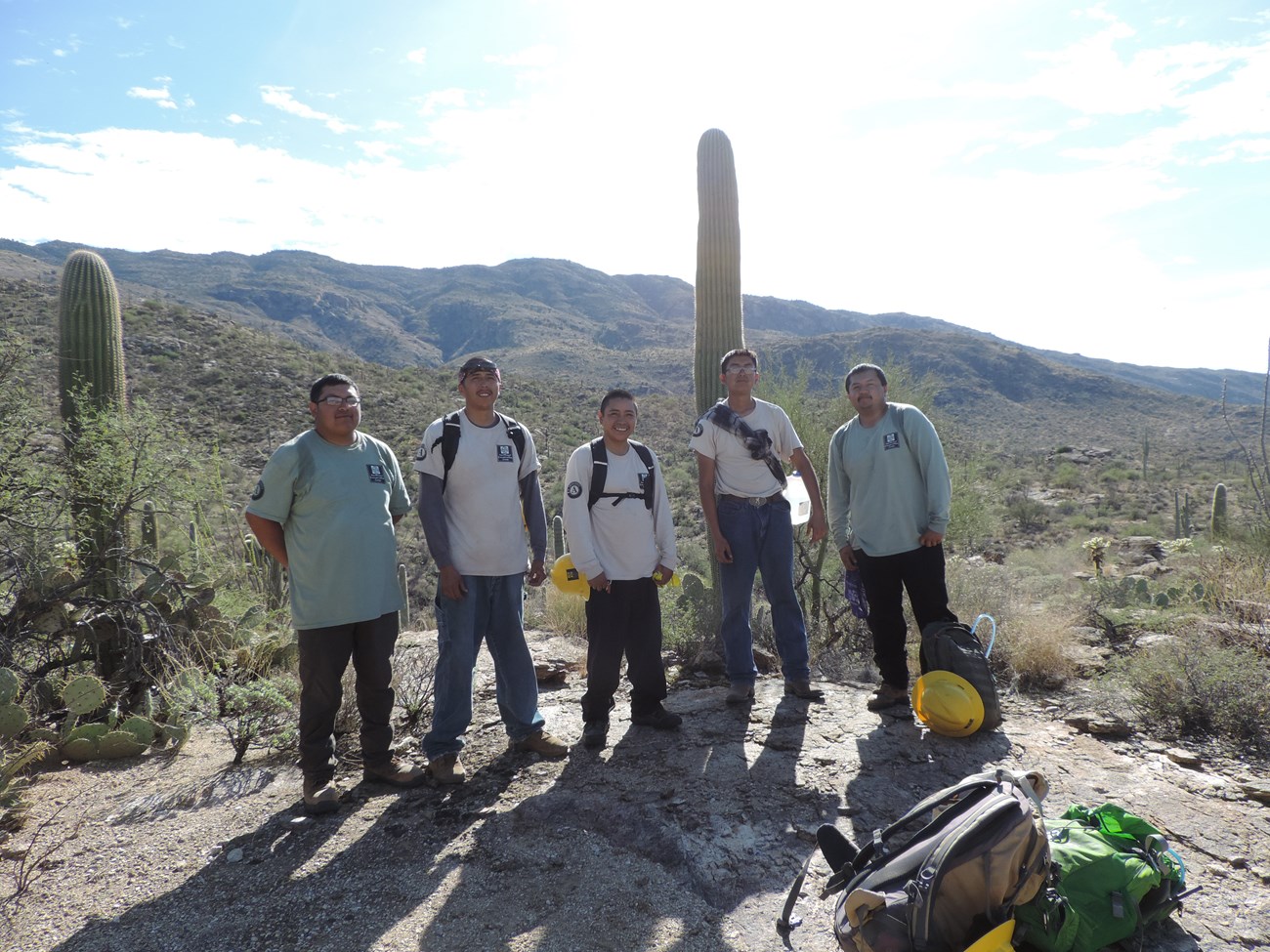Ancestral Lands Crew posing for a photo after the census. Behind them are mountains and saguaros.