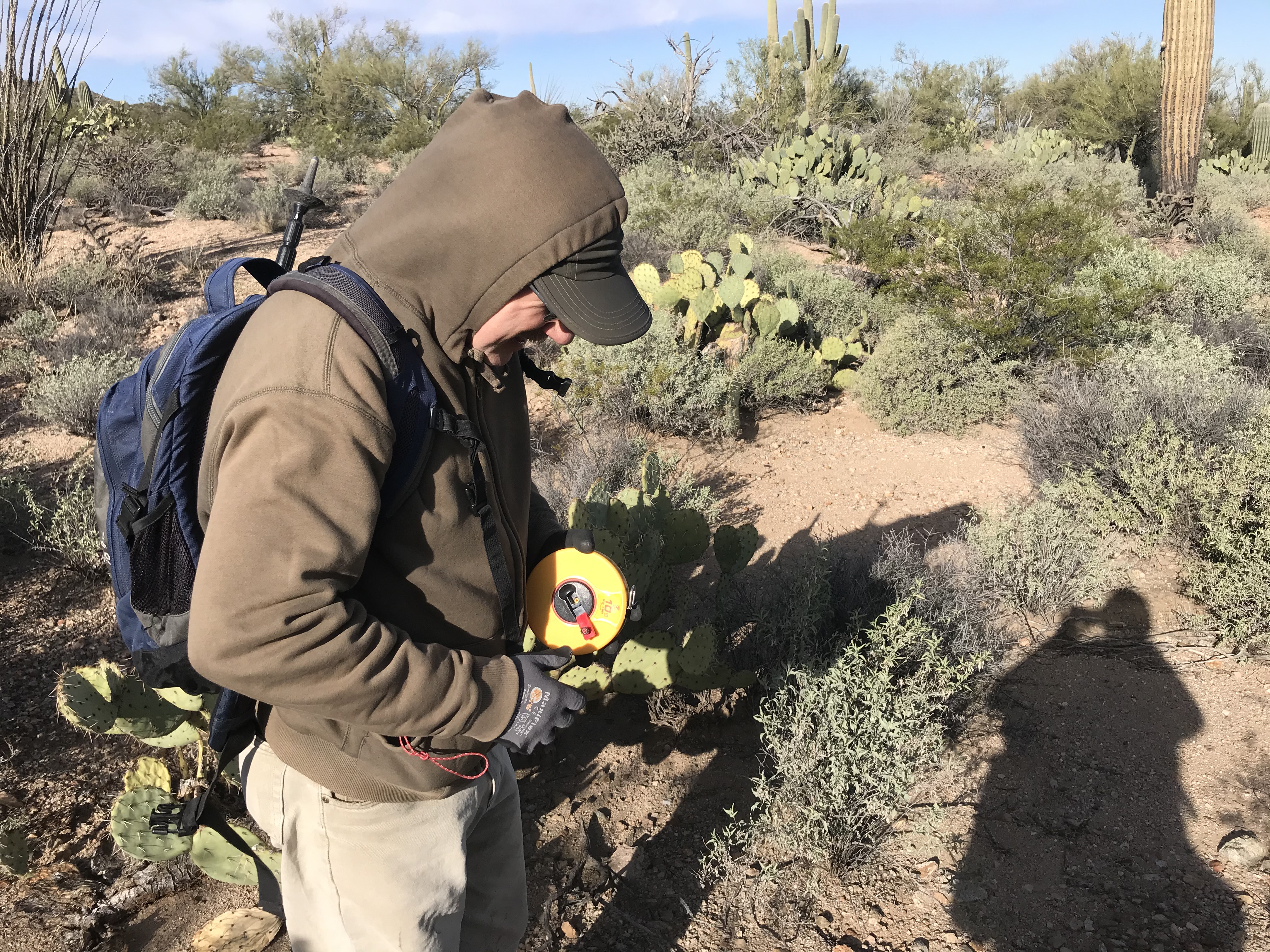 Volunteer winds up measuring tape