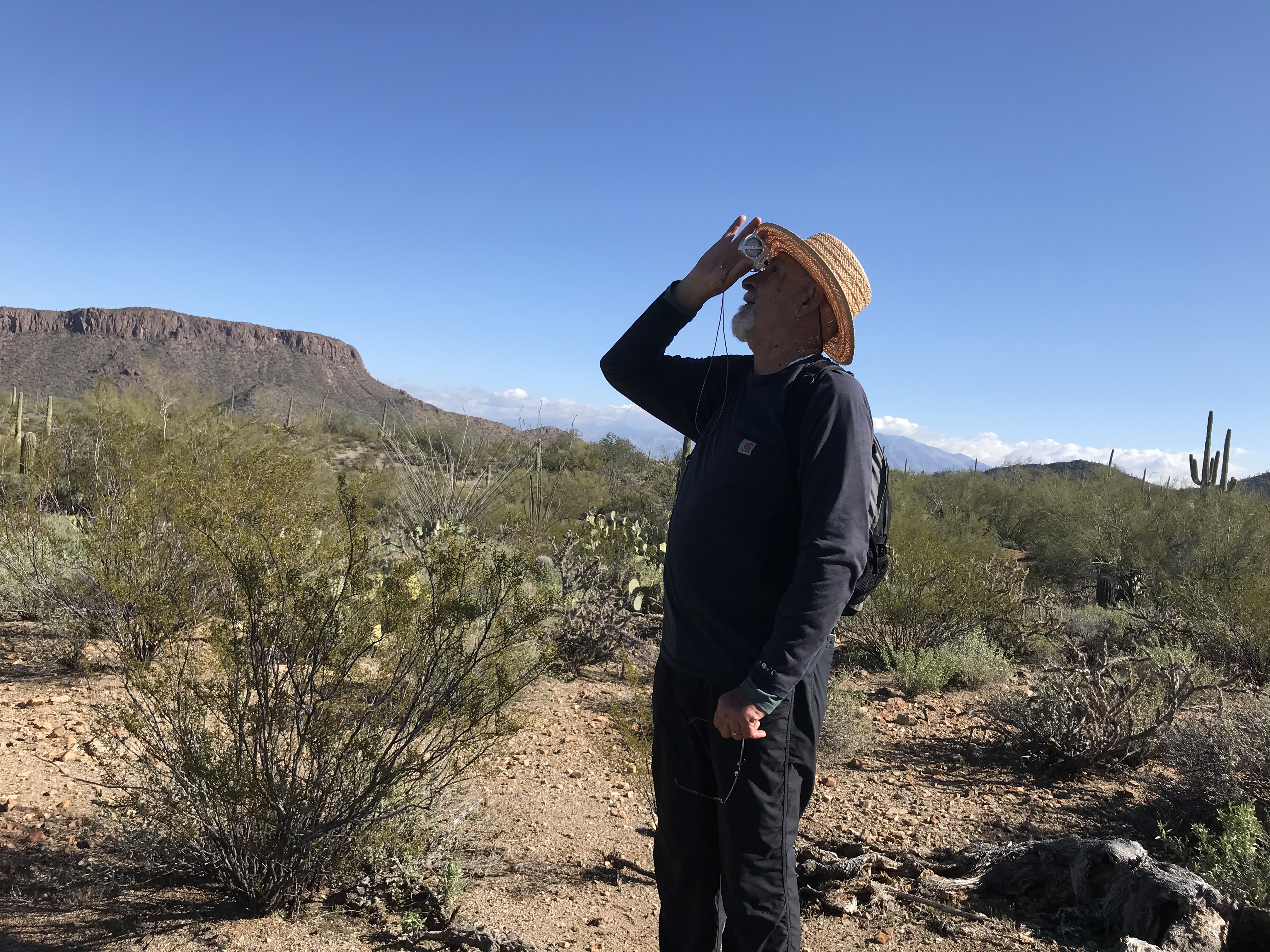 A volunteer looking through a clinometer.