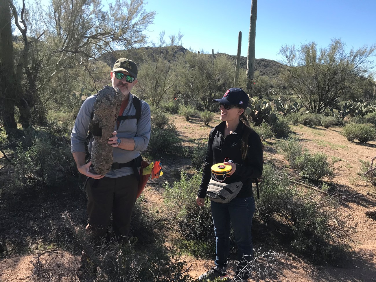 A volunteer holding a saguaro boot.