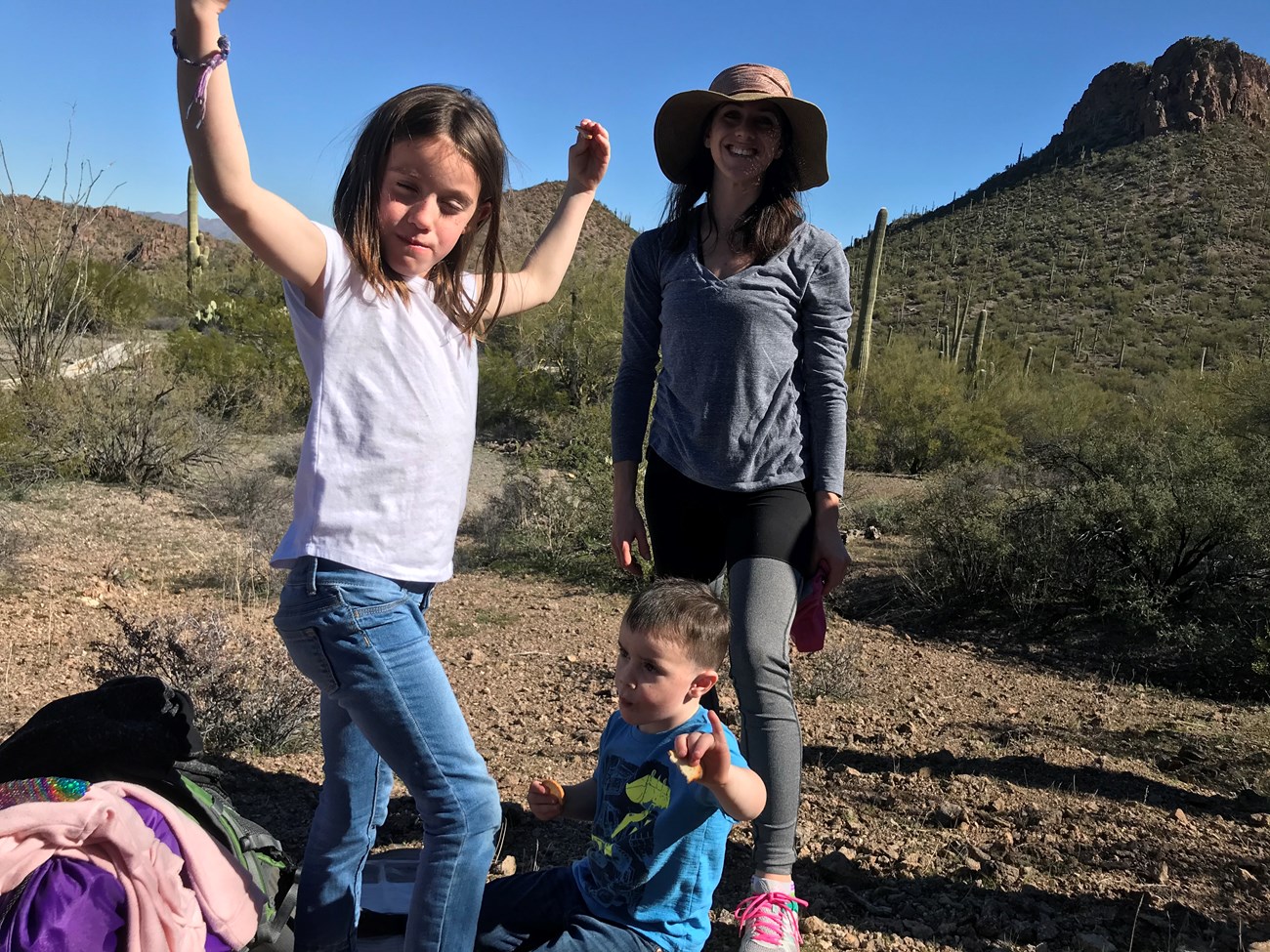 Young volunteers pose as saguaros during a snack break