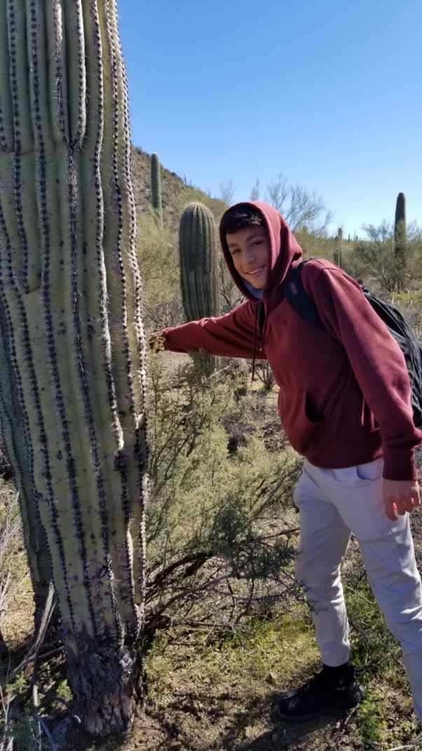 Volunteer smiles with saguaro