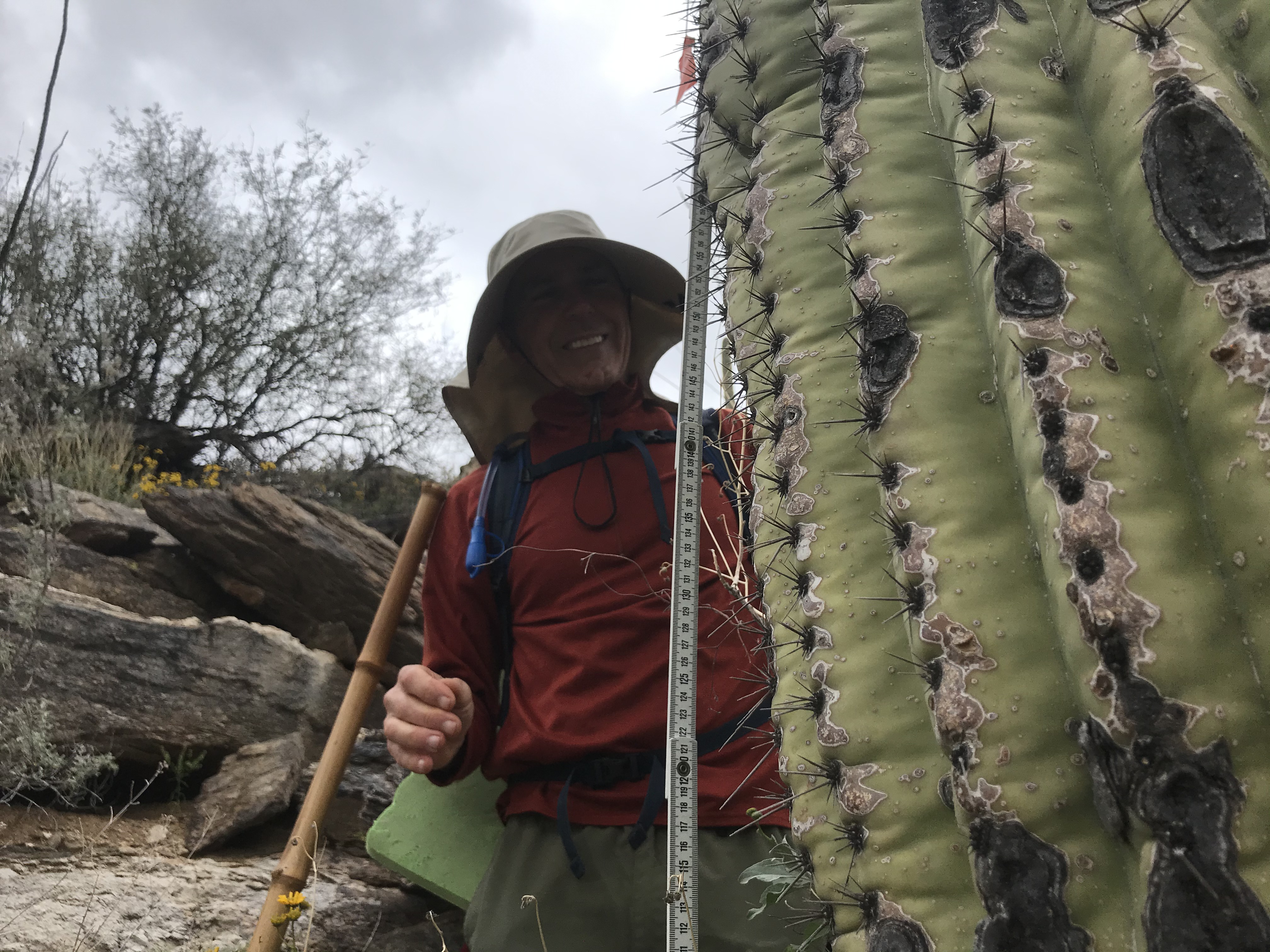 Adventure Scientist smiles with saguaro